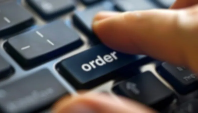 finger hovering over order button on a keyboard